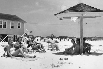 Vintage photo of people enjoying the beach in Gulf Shores in the 1950s.