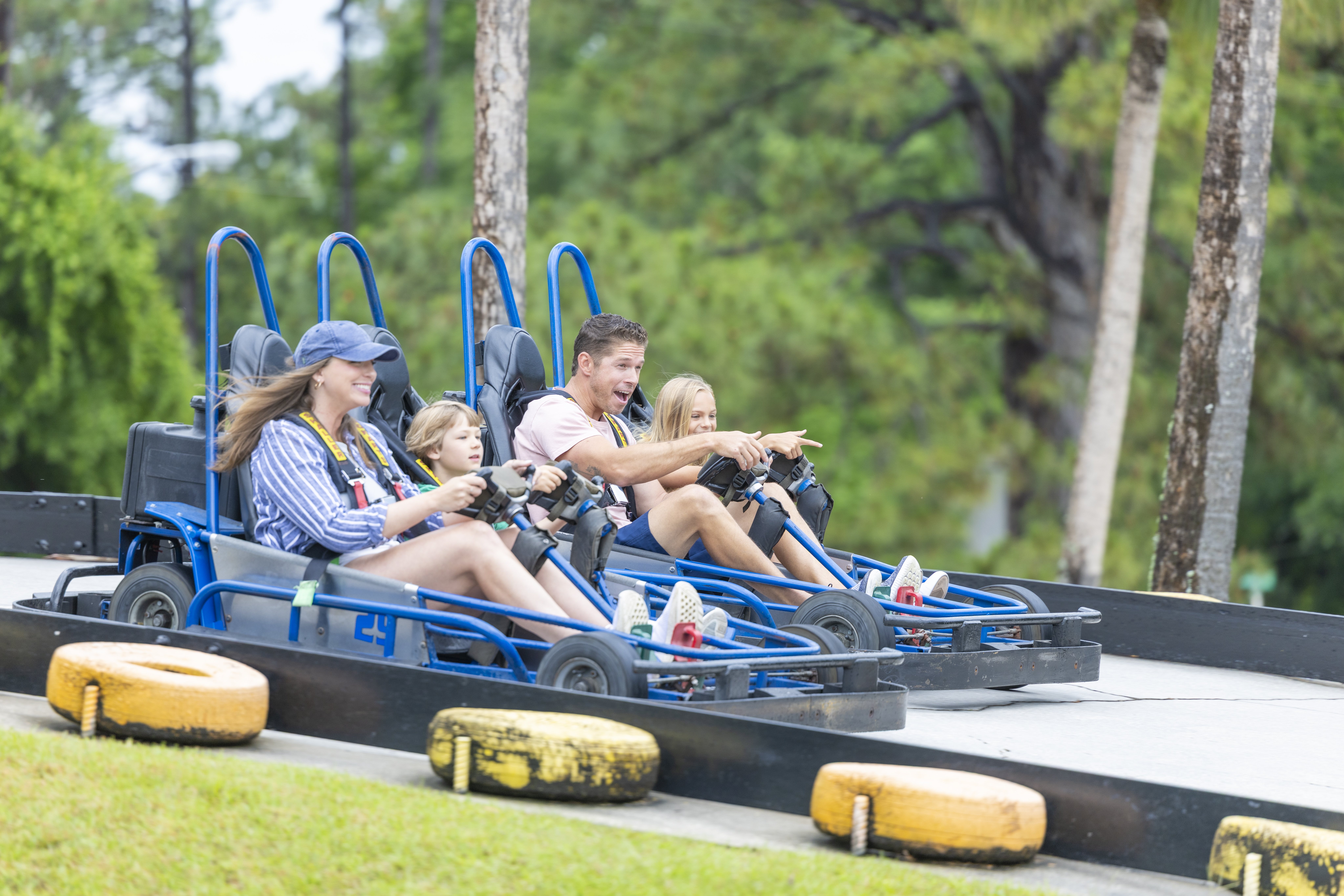 Family racing go-karts at The Track attraction in Gulf Shores