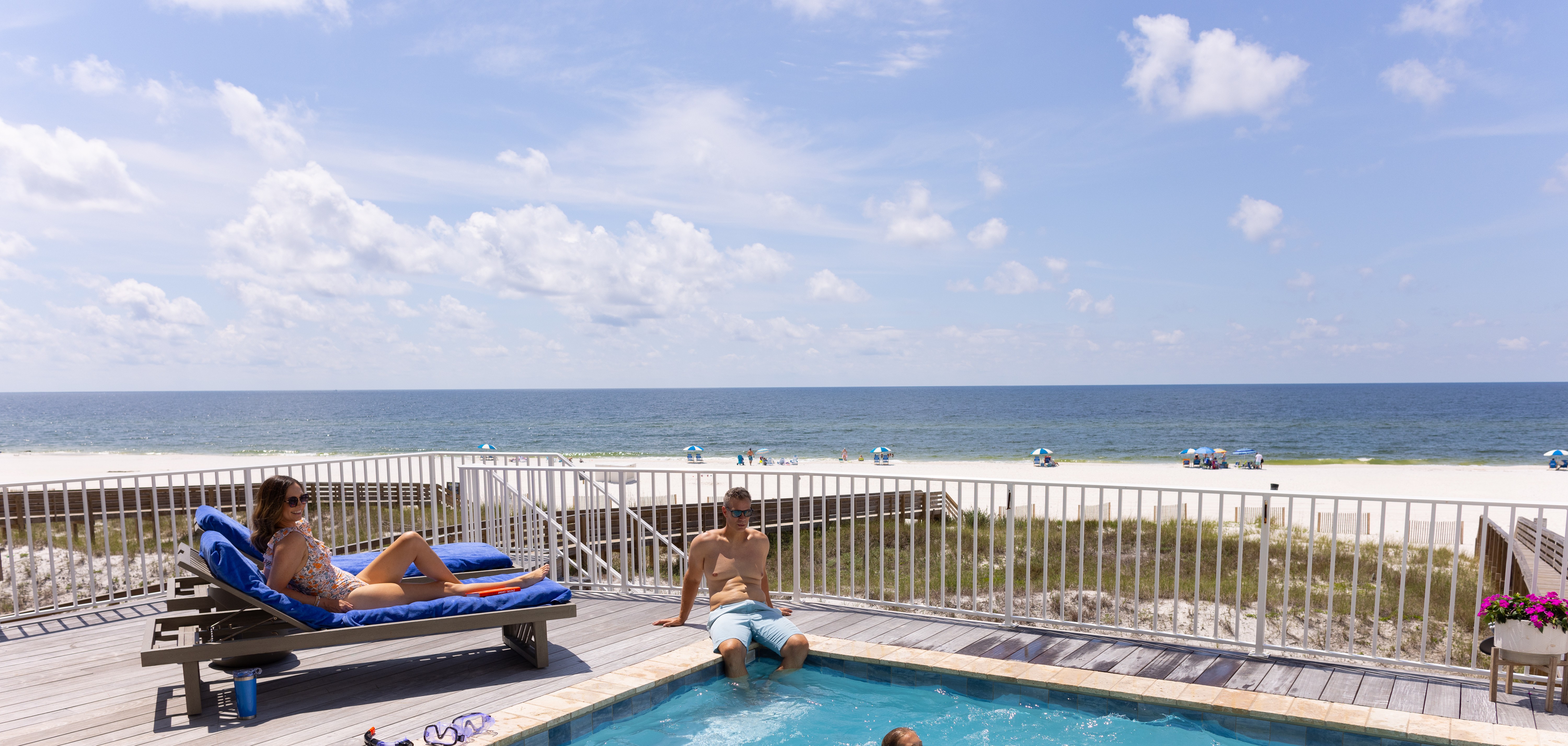 A family enjoying their beach house balcony