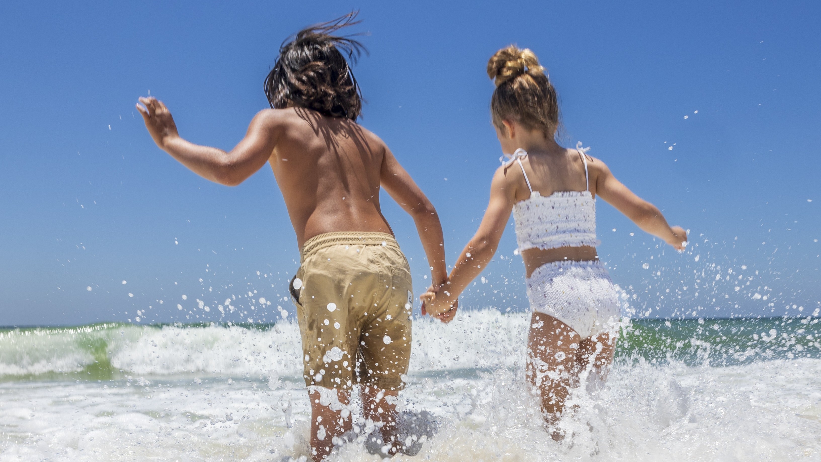kids running into the water at Alabama's Beaches