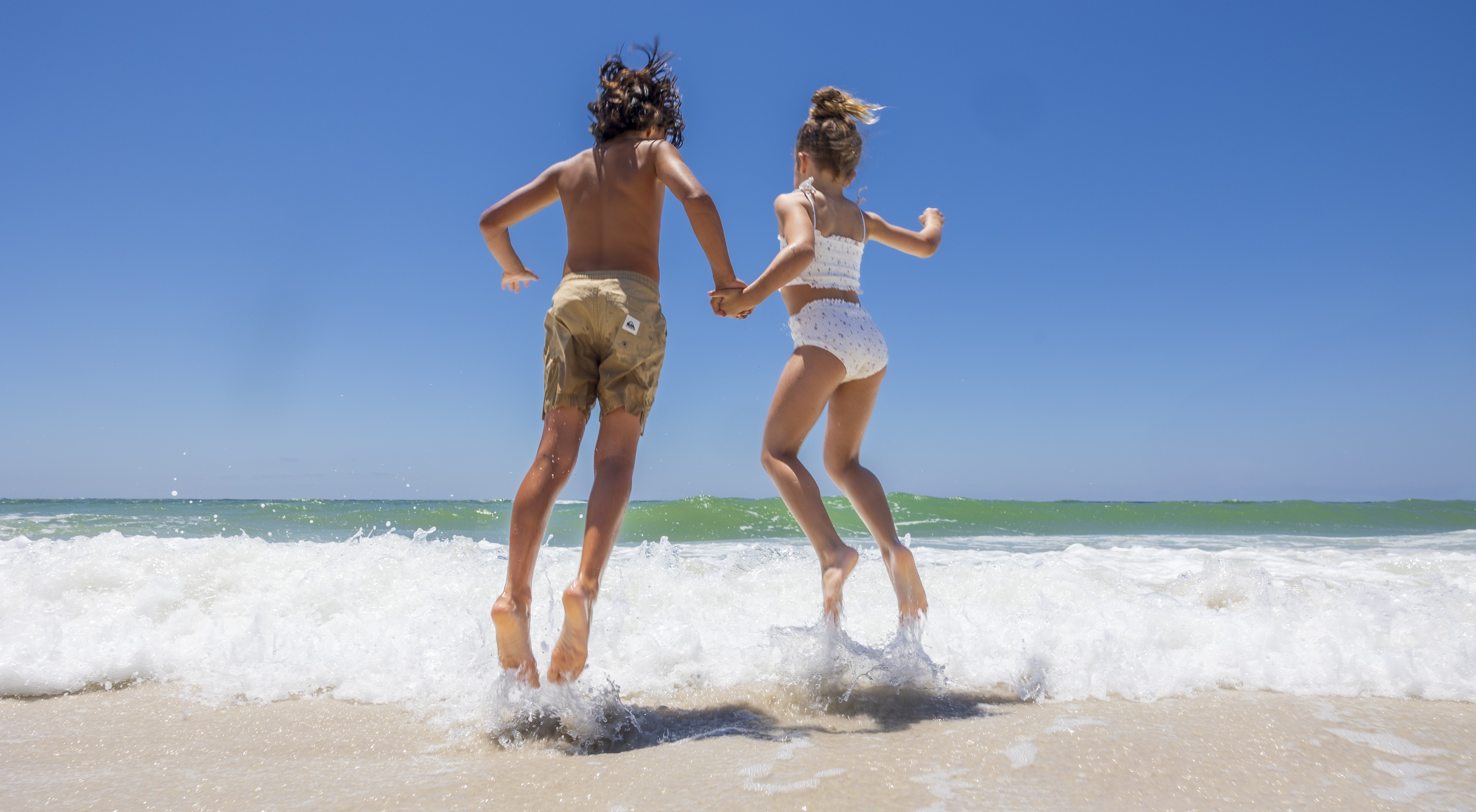 kids jumping into the water