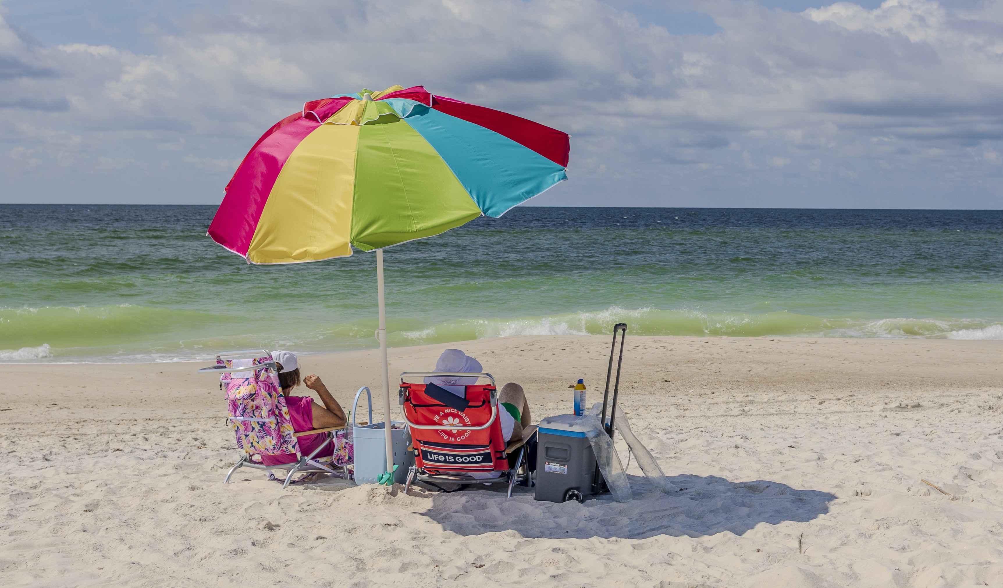 Rainbow umbrella and beach chairs along Alabama's Beaches