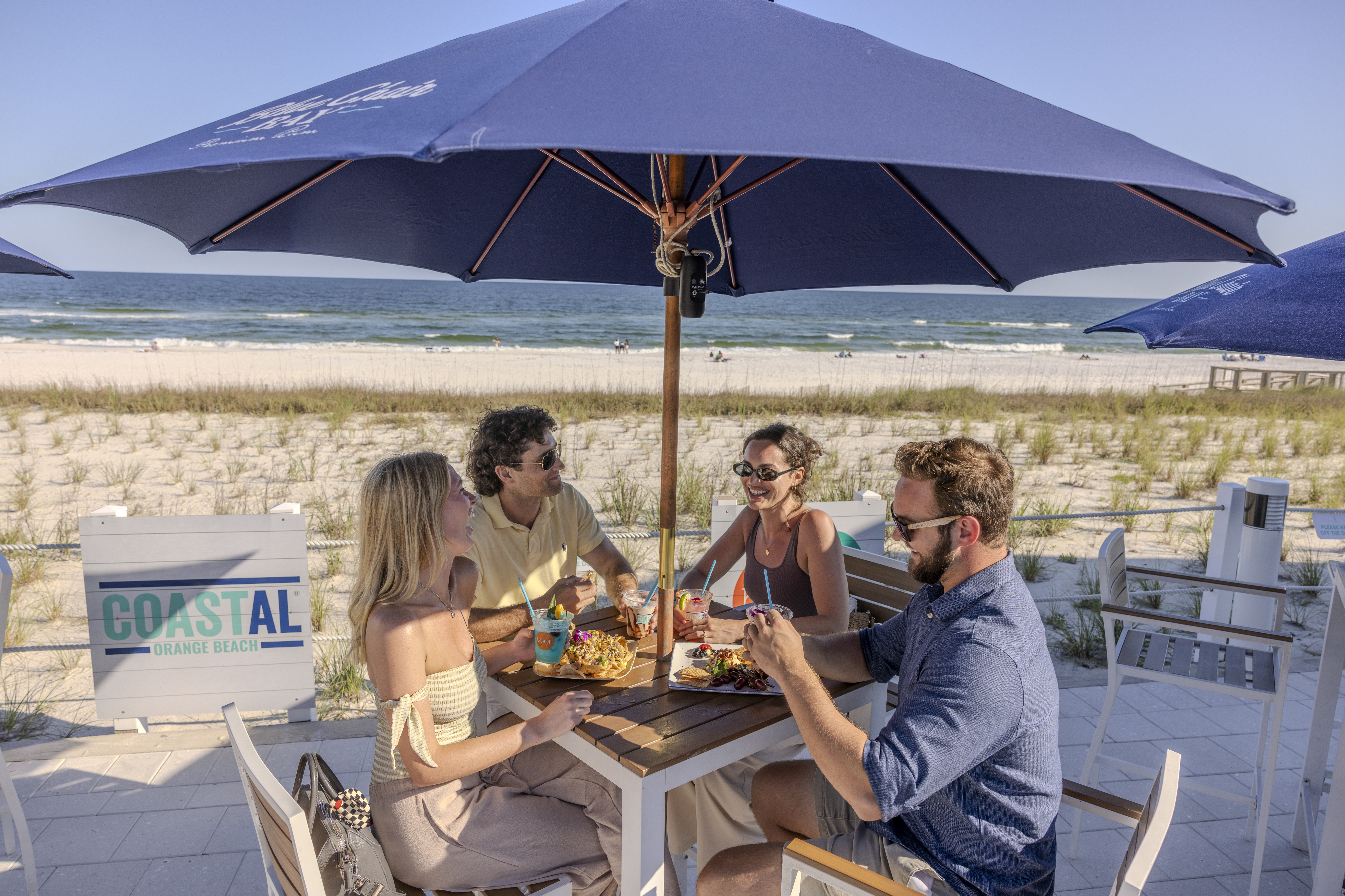 Friends dining at Coastal beachfront restaurant in Orange Beach