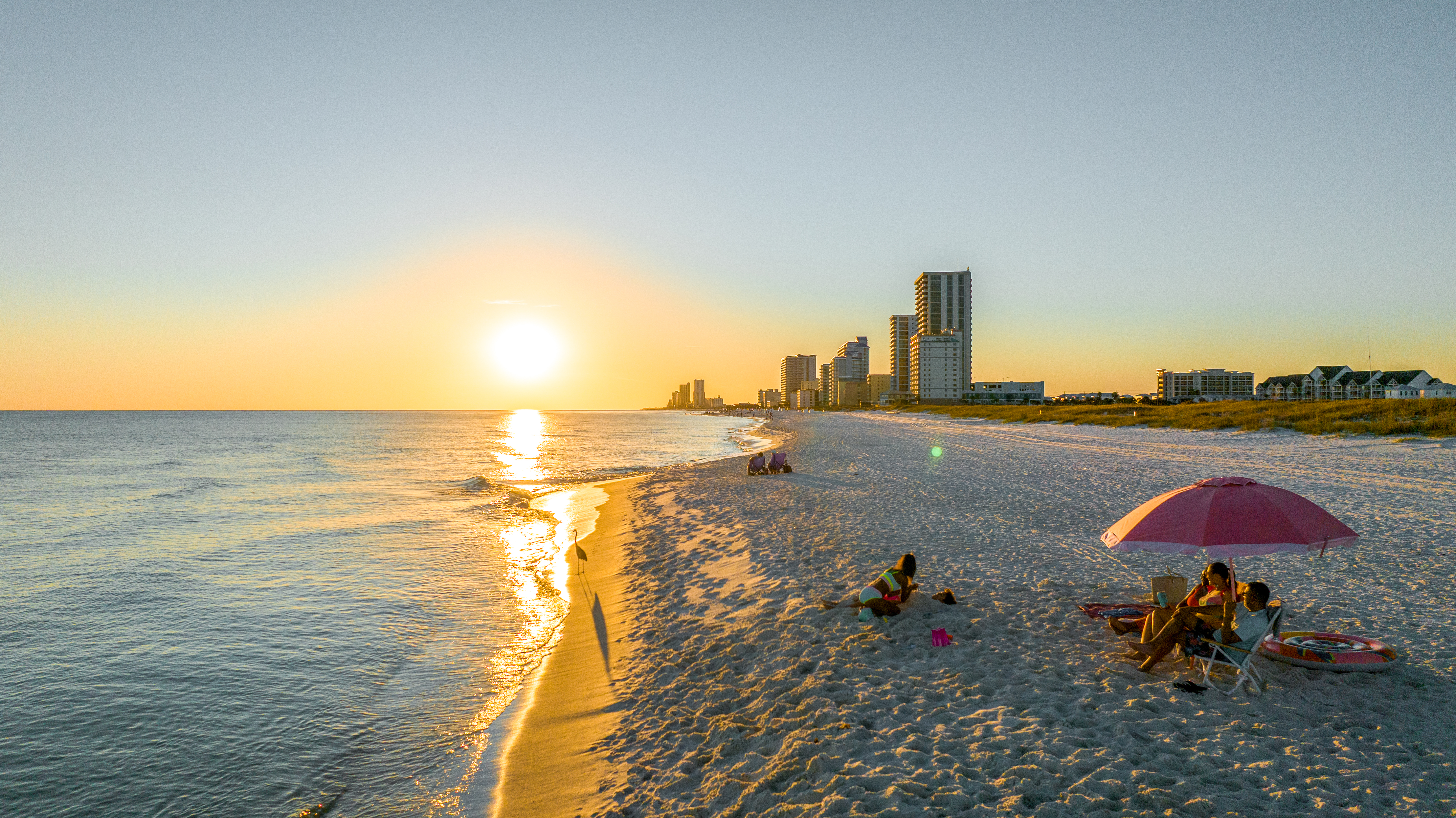 Family enjoying a fall sunset on Alabama's Beaches