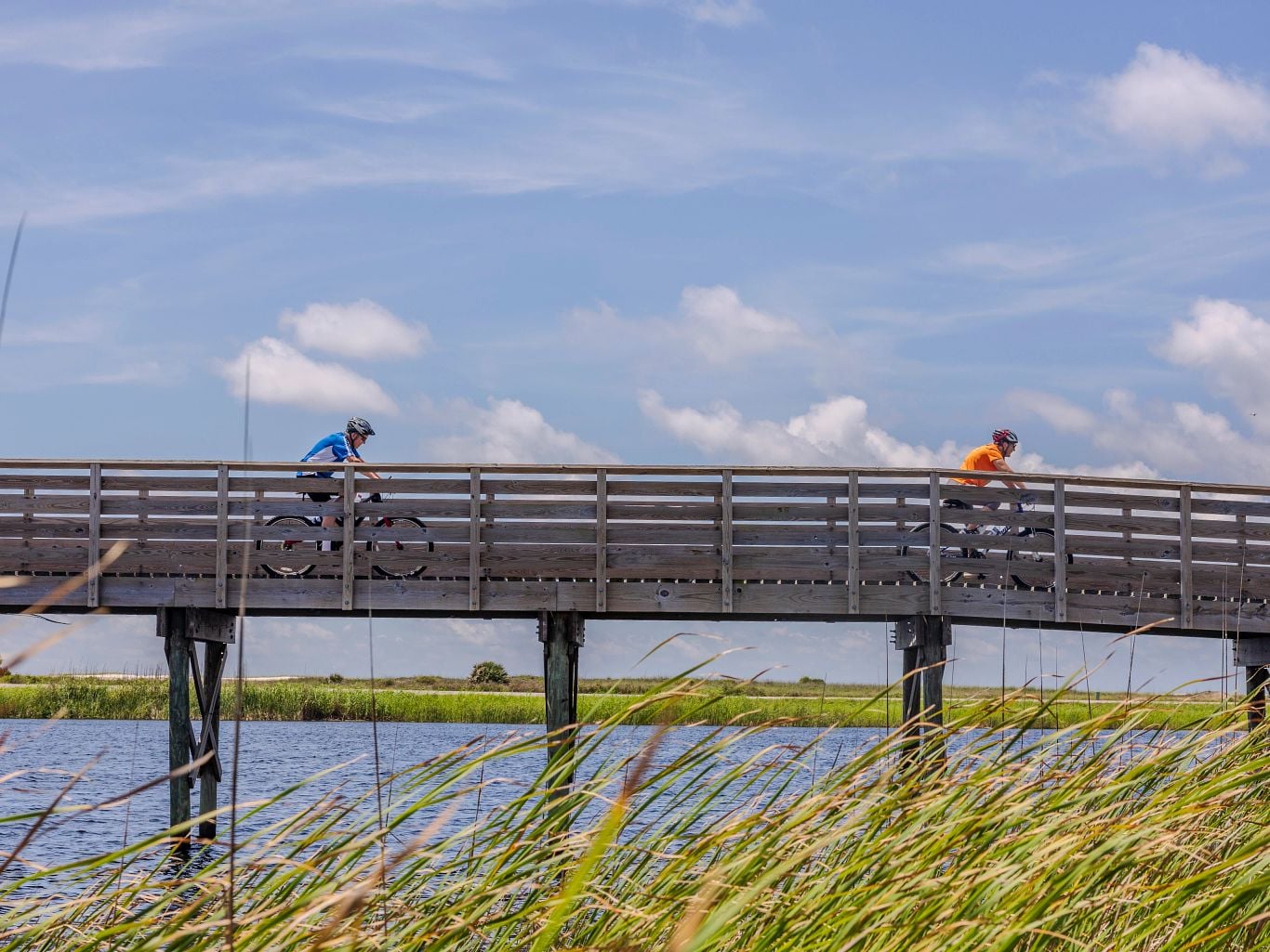 People biking over Lake Shelby in Gulf State Park