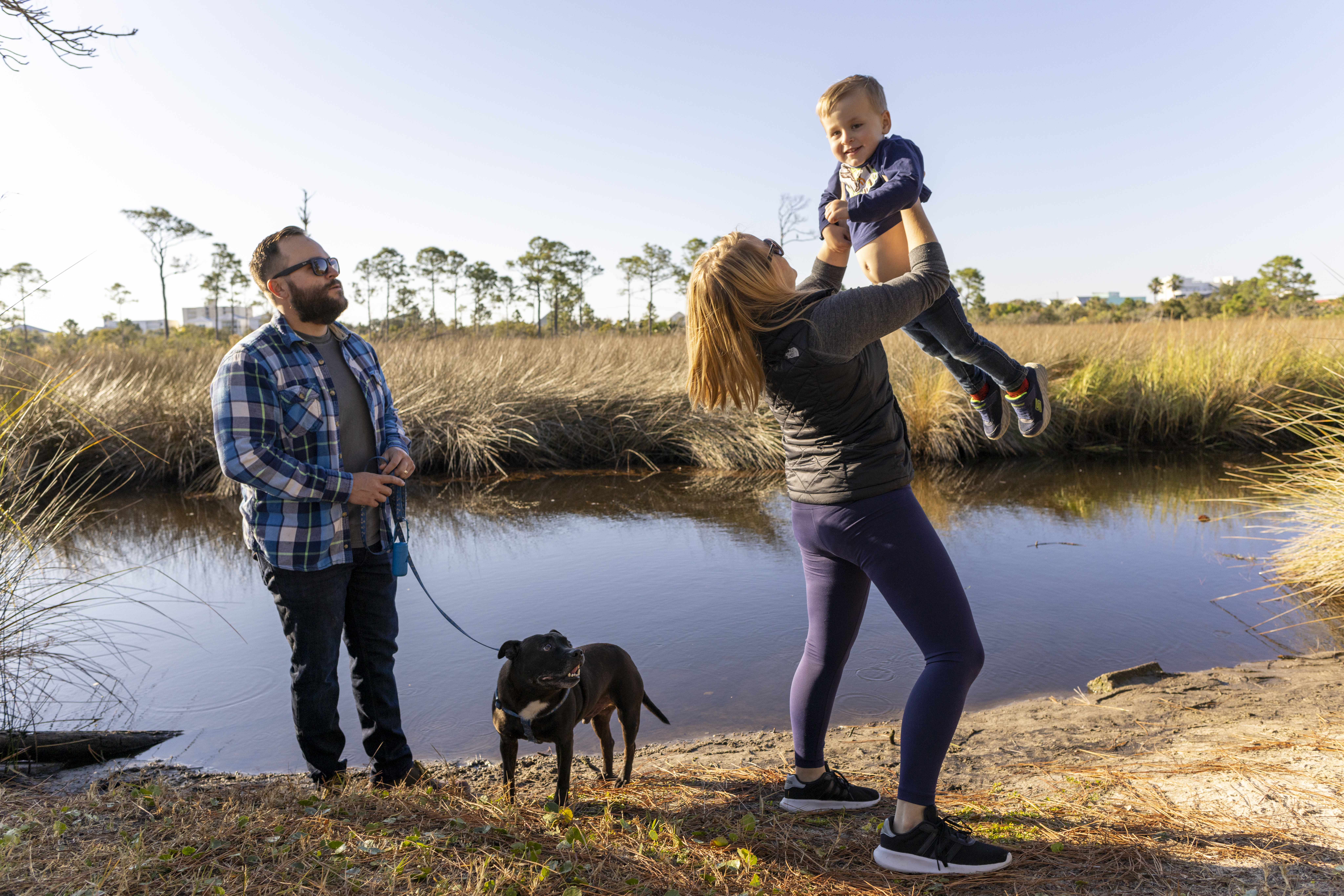 Family enjoying their time on Alabama's Beaches during winter with their pet