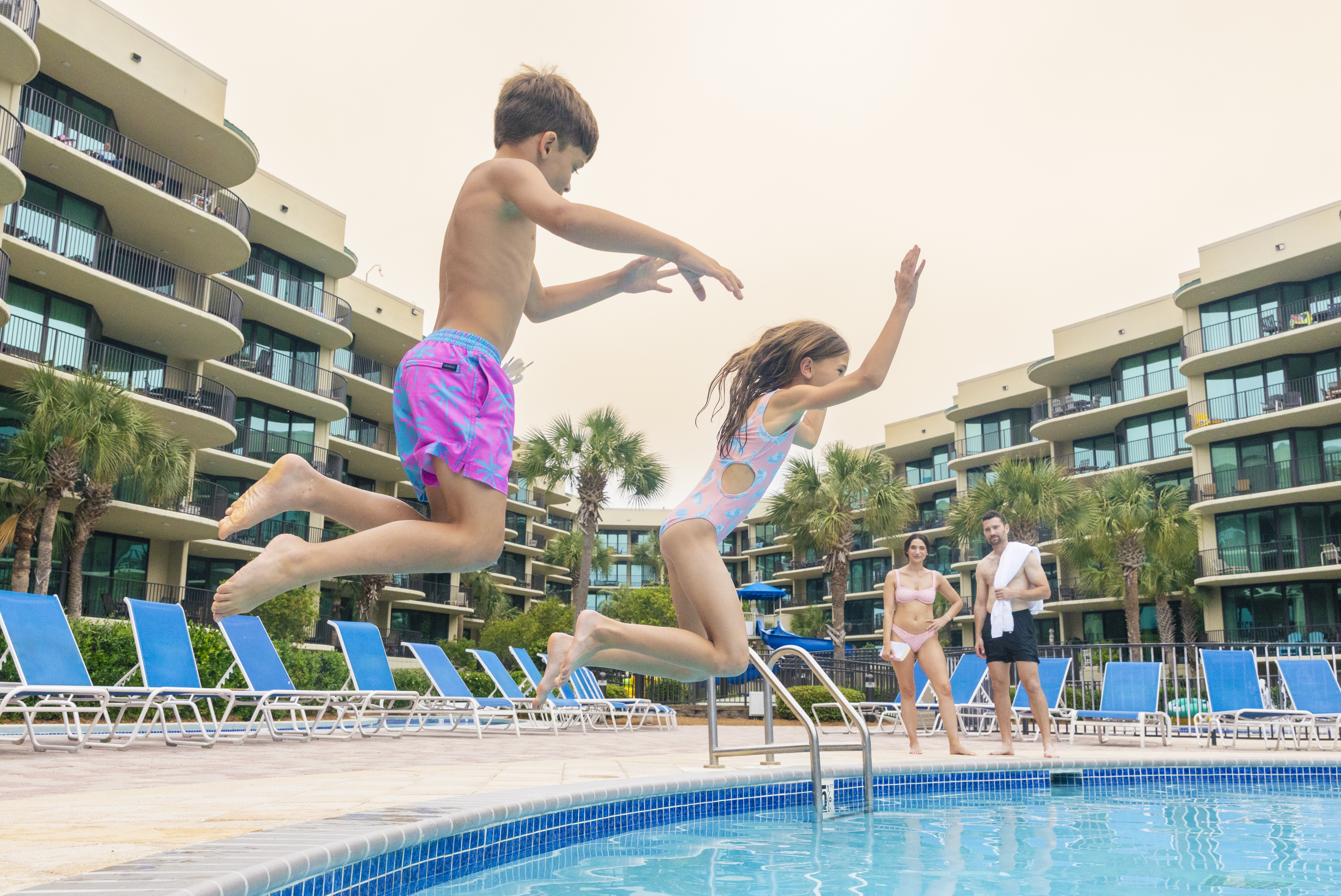 Kids jumping into the pool