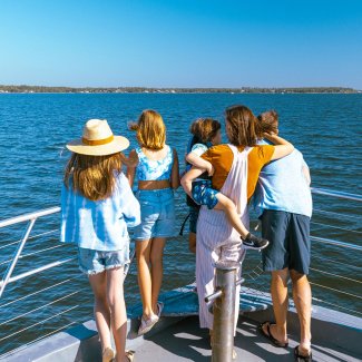 Family overlooking the Gulf aboard a dolphin cruise in Orange Beach