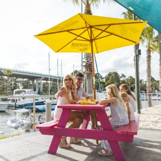 Family dining by the water at LuLu's seafood restaurant in Gulf Shores