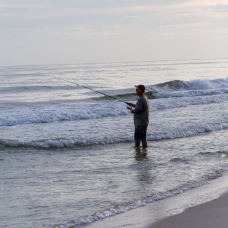 Angler surf fishing on the beaches of Gulf Shores
