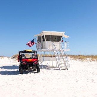 Lifeguard stand and beach safety vehicle at Perdido Pass public beach access point in Orange Beach