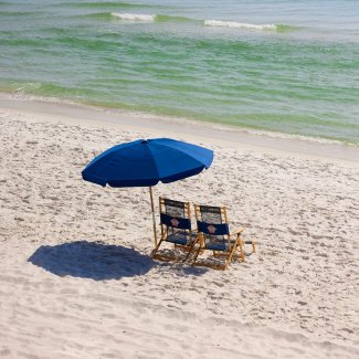 Beach chairs and umbrella sitting along the shoreline in Gulf Shores