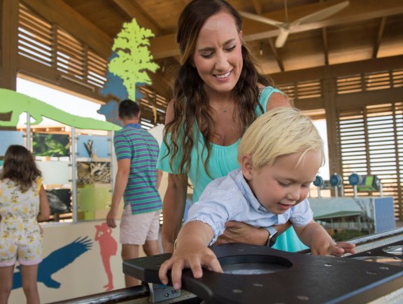 Mother and son exploring the Interpretive Center at Gulf State Park