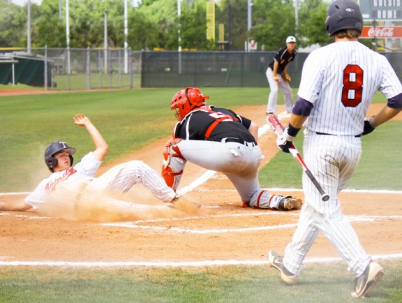 Player sliding into home plate, baseball tournaments in Gulf Shores