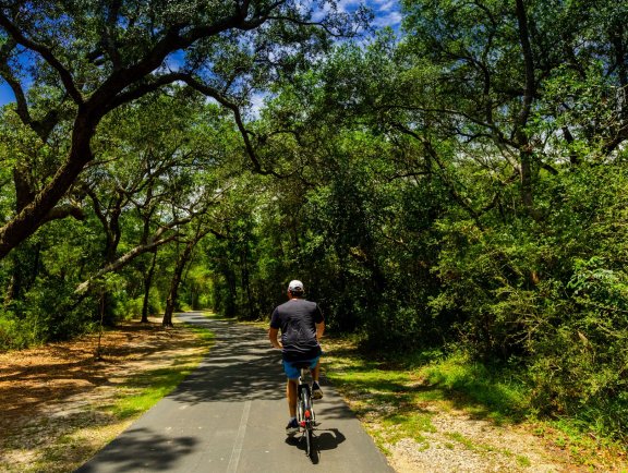 Man biking on trails in Gulf Shores, AL