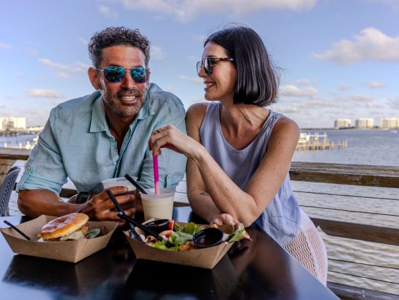 Couple dining at Avenue Pub waterfront restaurant in Orange Beach