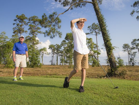 Dad and son golfing at Peninsula golf course in Gulf Shores