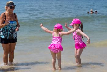 little girls playing on the beach