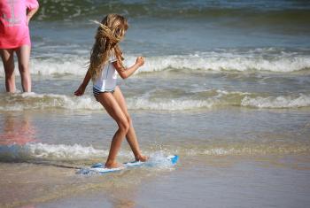Girl Skim Boarding Gulf Shores