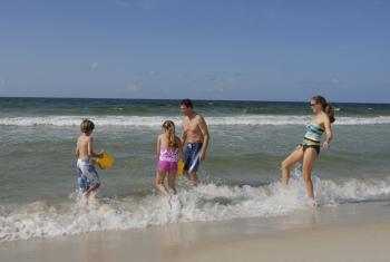family playing in the waves Orange Beach, Alabama
