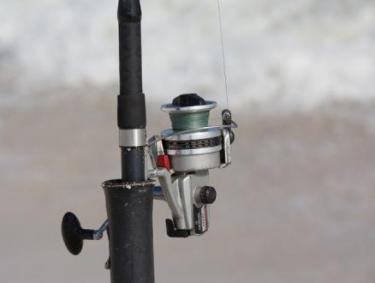rod and reel on the beach in Gulf Shores AL