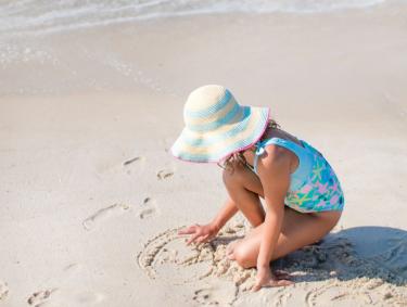 Young girl playing in the sand Gulf Shores, AL