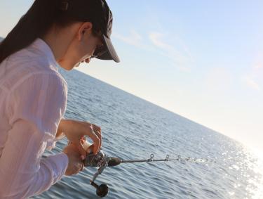 Woman offshore fishing on the Alabama Gulf Coast