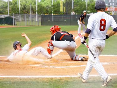 Player sliding into home plate, baseball tournaments in Gulf Shores