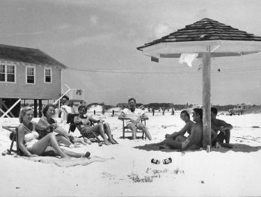 Vintage photo of people enjoying the beach in Gulf Shores in the 1950s.