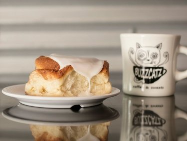 Cinnamon roll and cup of coffee at BuzzCatz Coffee shop in Orange Beach