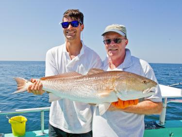 Anglers with a redfish caught in Orange Beach