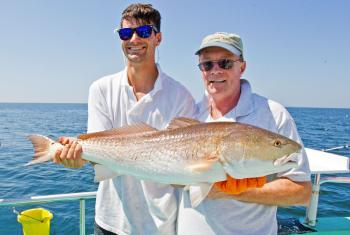 Anglers with a redfish caught in Orange Beach