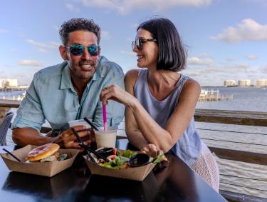 Couple dining at Avenue Pub waterfront restaurant in Orange Beach