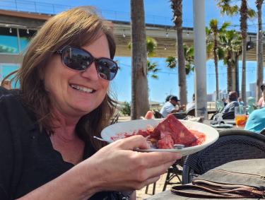 Sara Broers with bread pudding at Cobalt, waterfront restaurant in Orange Beach