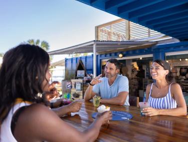 People dining outside at The Gulf waterfront restaurant in Orange Beach