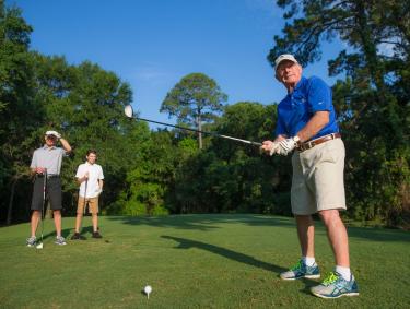Family playing golf at Peninsula Golf and Racquet Club in Gulf Shores