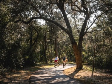 Couple biking along the Hugh S. Branyon Backcountry Trail in Gulf State Park
