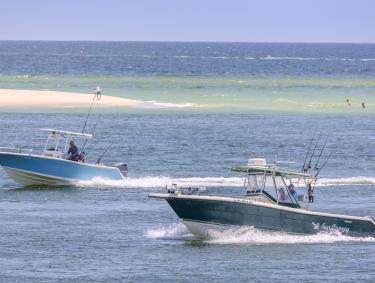 Boats cruising through Perdido Pass in Orange Beach