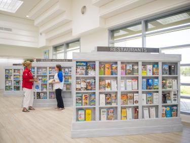 Visitor Services expert helping a guest at the Orange Beach Welcome Center