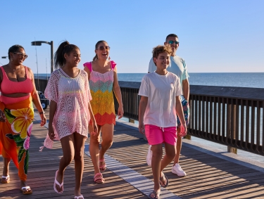 Family walking along the Gulf State Park Pier in Gulf Shores