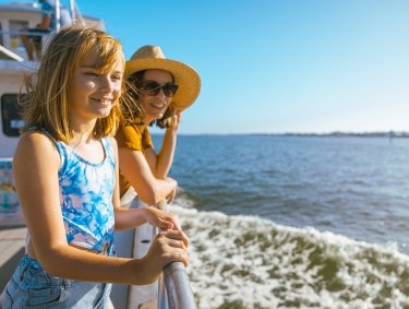 Mom and daughter on a dolphin cruise in Orange Beach