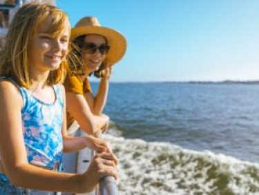 Mom and daughter on a dolphin cruise in Orange Beach
