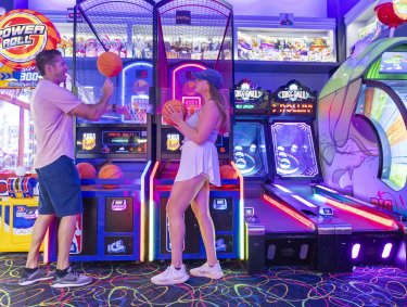 A couple playing game at The Track arcade.