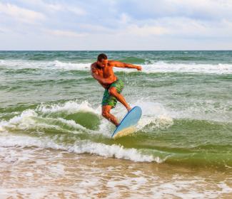 man skim boarding in Gulf Shores Orange Beach Al