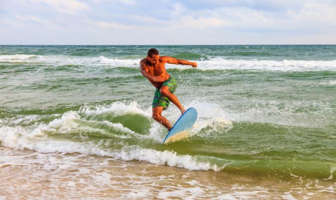 man skim boarding in Gulf Shores Orange Beach Al