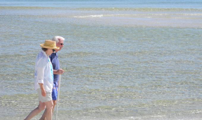 Older couple walking Orange beach
