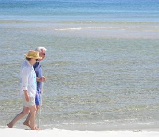 Older couple walking Orange beach