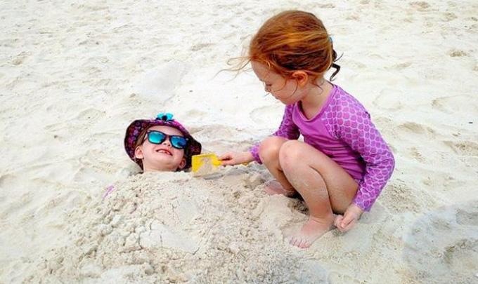 Kids play in sand at Beach in Gulf Shores AL