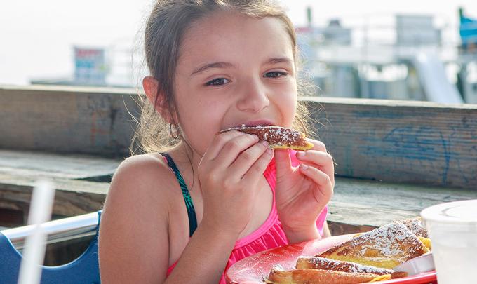 girl eating at Orange Beach restaurant