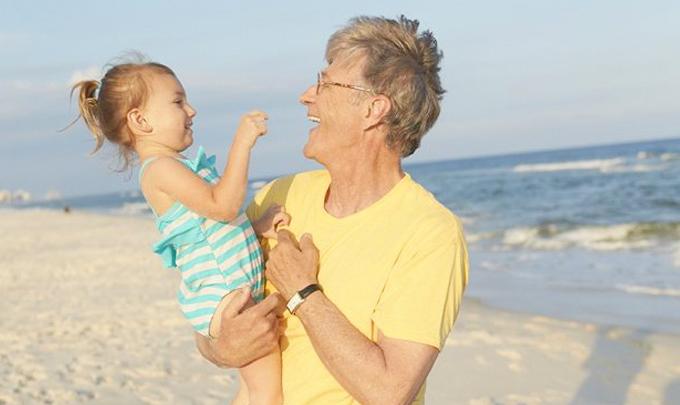 Man holding baby on Gulf Shores Al beach